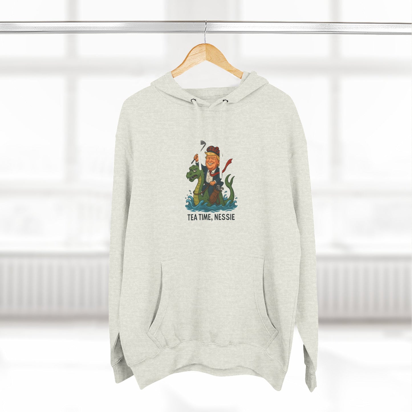 Nessie Tea Time Hoodie, Cozy Sweatshirt for Dragon Lovers, Gift for Tea Enthusiasts, Fun Highland Mythology Apparel, Comfortable Casual Wear Printify